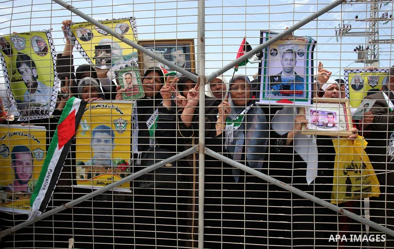 Palestinians women hold pictures of jailed relatives during a protest calling for their release from Israeli prisons near Erez crossing between Israel and the northern Gaza Strip on May 28, 2011. Photo by Yasser Fathi