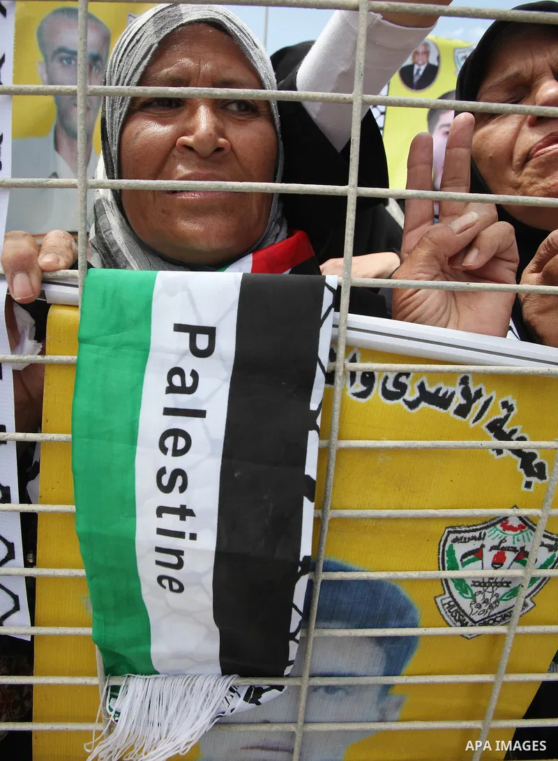 Palestinians women hold pictures of jailed relatives during a protest calling for their release from Israeli prisons near Erez crossing between Israel and the northern Gaza Strip on May 28, 2011. Photo by Yasser Fathi