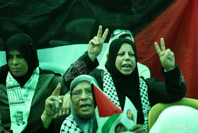 Palestinians women hold pictures of jailed relatives during a protest calling for their release from Israeli prisons near Erez crossing between Israel and the northern Gaza Strip on May 28, 2011. Photo by Yasser Fathi