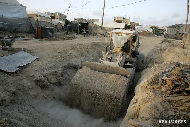 Palestinian men smuggle gravels into the Gaza Strip through a tunnel under the Egypt-Gaza border in Rafah on May 28, 2011. Egypt on Saturday reopened its Rafah border with the Gaza Strip, allowing people to cross freely...