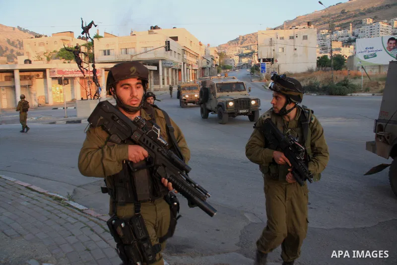 Israeli soldiers take a positions during clashes with Palestinians after Jews pray at the biblical Joseph's Tomb in the West Bank city of Nablus early on May 30, 2011. Photo by Wagdi Eshtayah