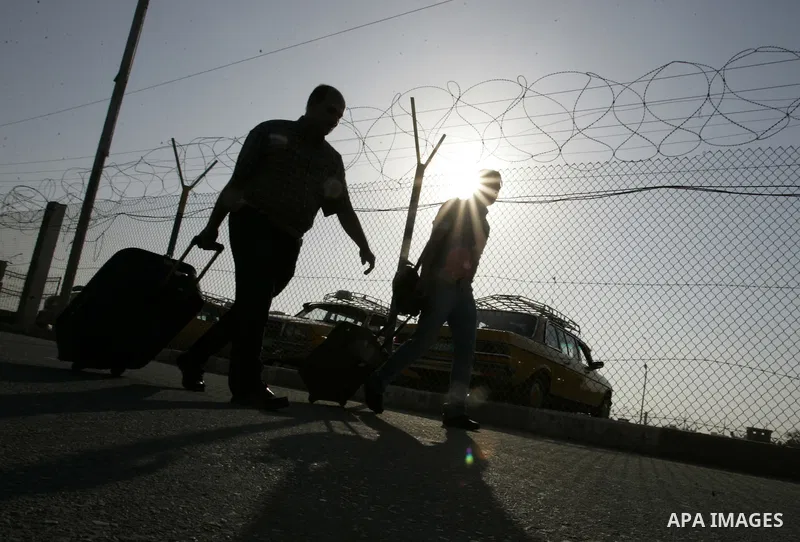 Palestinians wait to cross into Egypt through the Rafah border crossing in the southern Gaza Strip on May 30, 2011. Egypt eased travel restrictions for residents of Gaza from Saturday, and eroding a blockade that imposed...