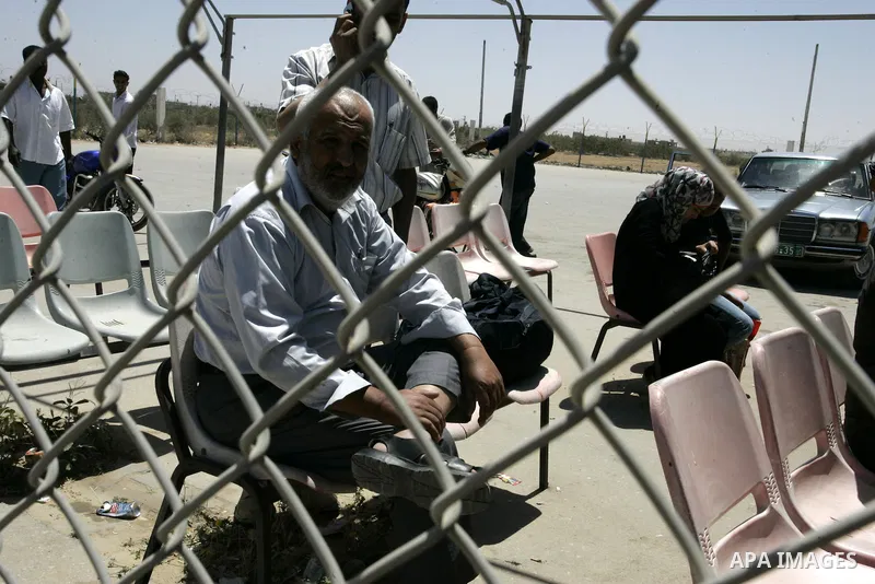 Palestinians wait to cross into Egypt through the Rafah border crossing in the southern Gaza Strip on May 30, 2011. Egypt eased travel restrictions for residents of Gaza from Saturday, and eroding a blockade that imposed...