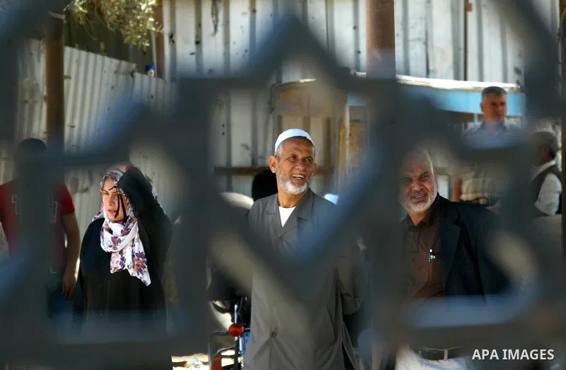 Palestinians wait to cross into Egypt through the Rafah border crossing in the southern Gaza Strip on May 30, 2011. Egypt eased travel restrictions for residents of Gaza from Saturday, and eroding a blockade that imposed...