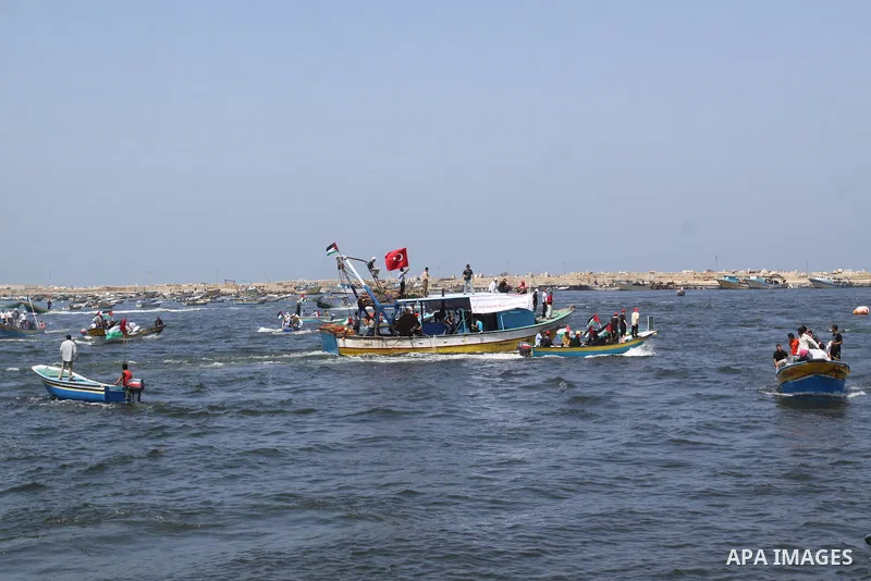 Palestinians ride boats in the Mediterranean Sea off the coast of Gaza City May 30, 2011, during a rally marking the first anniversary of the death of nine Turks, who were shot dead last May when Israeli naval commandos...