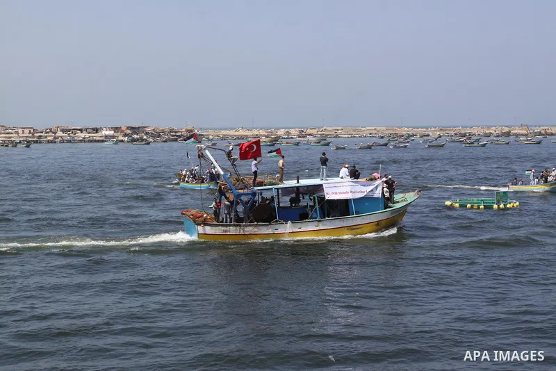 Palestinians ride boats in the Mediterranean Sea off the coast of Gaza City May 30, 2011, during a rally marking the first anniversary of the death of nine Turks, who were shot dead last May when Israeli naval commandos...