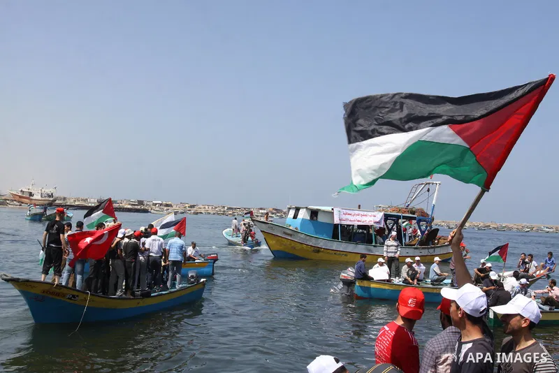 Palestinians ride boats in the Mediterranean Sea off the coast of Gaza City May 30, 2011, during a rally marking the first anniversary of the death of nine Turks, who were shot dead last May when Israeli naval commandos...