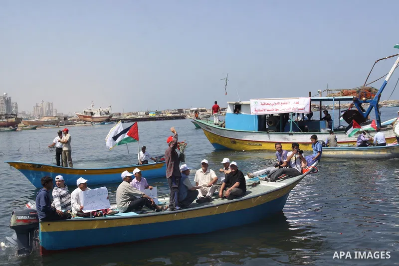 Palestinians ride boats in the Mediterranean Sea off the coast of Gaza City May 30, 2011, during a rally marking the first anniversary of the death of nine Turks, who were shot dead last May when Israeli naval commandos...