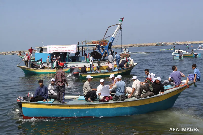 Palestinians ride boats in the Mediterranean Sea off the coast of Gaza City May 30, 2011, during a rally marking the first anniversary of the death of nine Turks, who were shot dead last May when Israeli naval commandos...