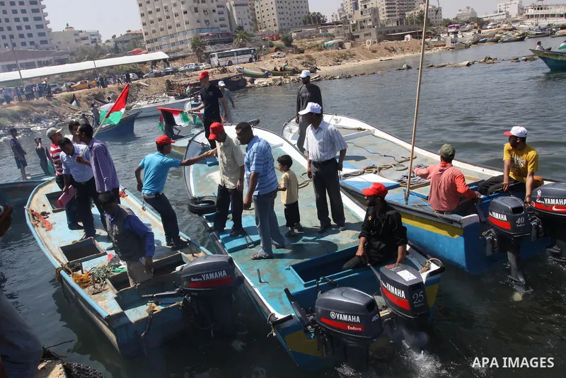 Palestinians ride boats in the Mediterranean Sea off the coast of Gaza City May 30, 2011, during a rally marking the first anniversary of the death of nine Turks, who were shot dead last May when Israeli naval commandos...