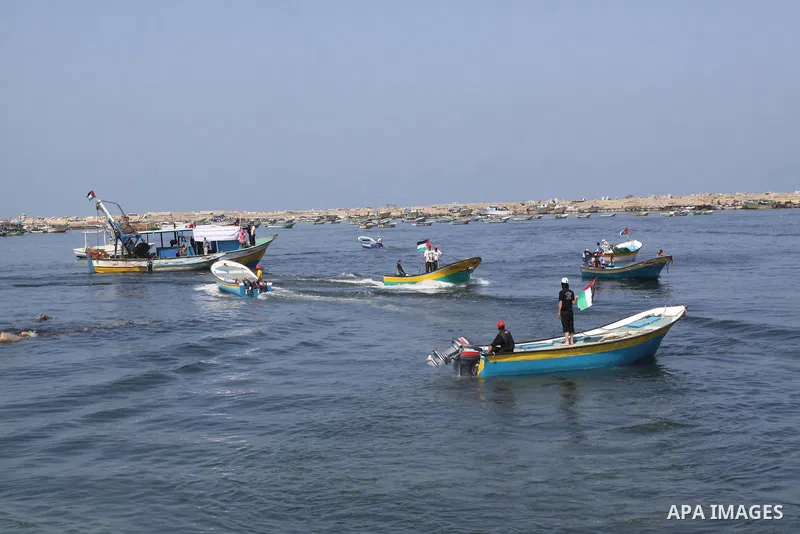 Palestinians ride boats in the Mediterranean Sea off the coast of Gaza City May 30, 2011, during a rally marking the first anniversary of the death of nine Turks, who were shot dead last May when Israeli naval commandos...