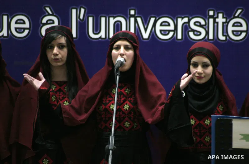 Palestinian youths sing as Palestinian prime minister Salam Fayyad attends the opening ceremony during the inauguration of Yasser Arafat Building at Hebron University in the Palestinian city of Hebron in the West Bank on...
