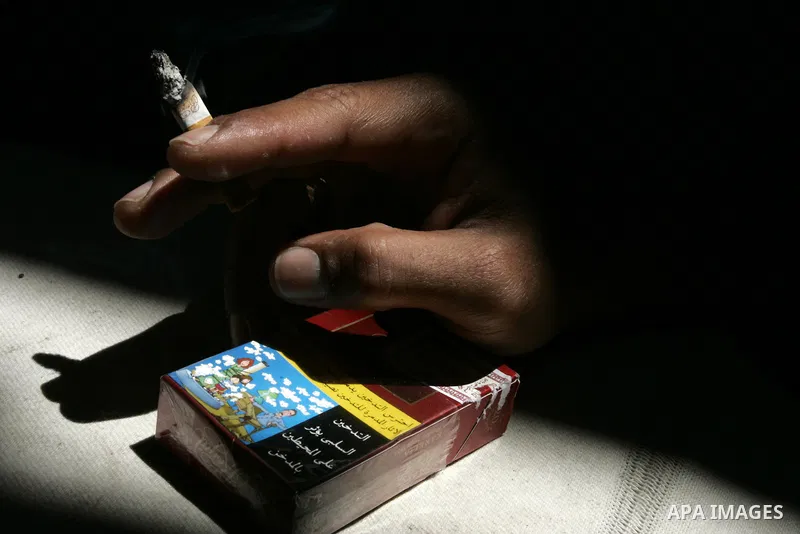 Palestinian man smokes cigarettes in Rafah, southern Gaza Strip on May 31, 2011. during the World No Tobacco Day, Middle East of some 240 million people soared 47 percent in the 1990s and has one of the highest smoking r...