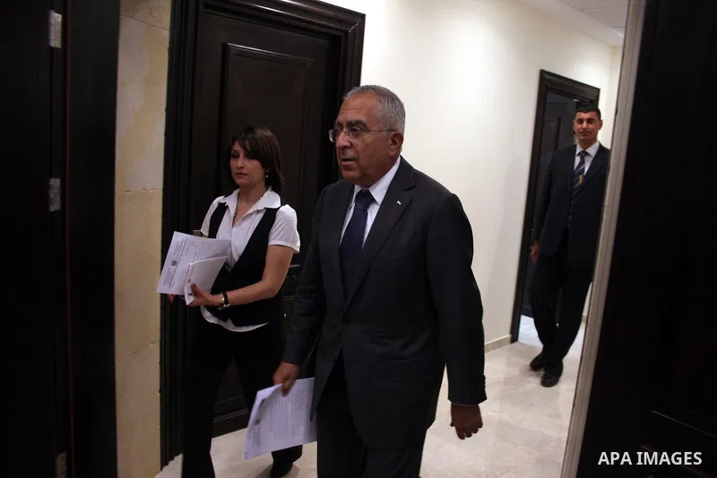 Palestinian Prime Minister Salam Fayyad attend a joint press conference with the Representative of Japan, Naofumi Hashimoto and the EU Representative, Christian Berger during signing an agreement in the West Bank city of...