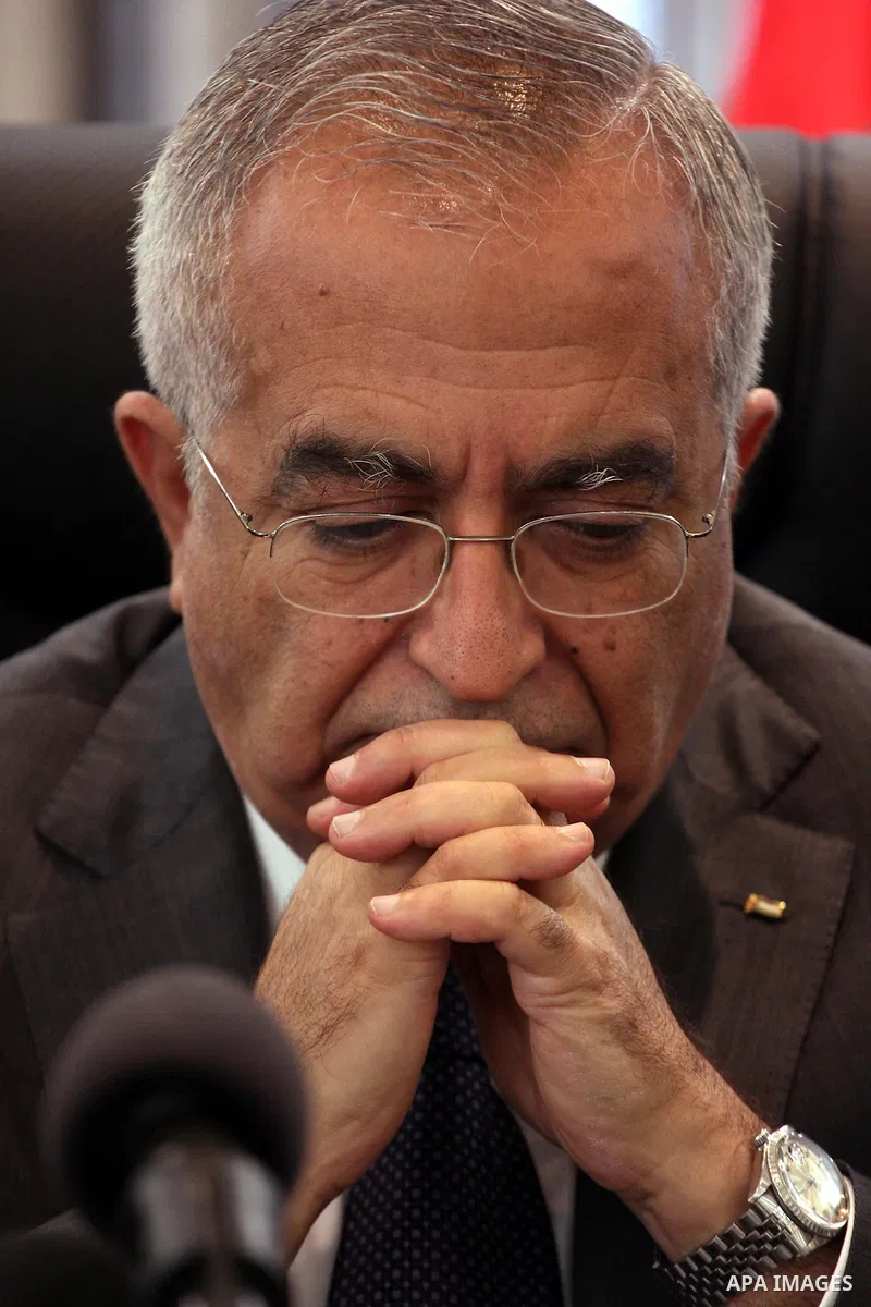Palestinian Prime Minister Salam Fayyad attend a joint press conference with the Representative of Japan, Naofumi Hashimoto and the EU Representative, Christian Berger during signing an agreement in the West Bank city of...