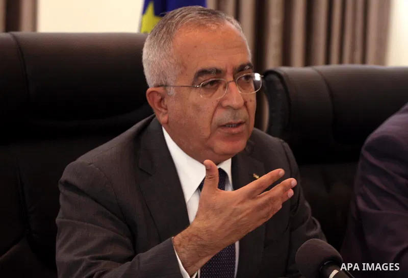 Palestinian Prime Minister Salam Fayyad attend a joint press conference with the Representative of Japan, Naofumi Hashimoto and the EU Representative, Christian Berger during signing an agreement in the West Bank city of...