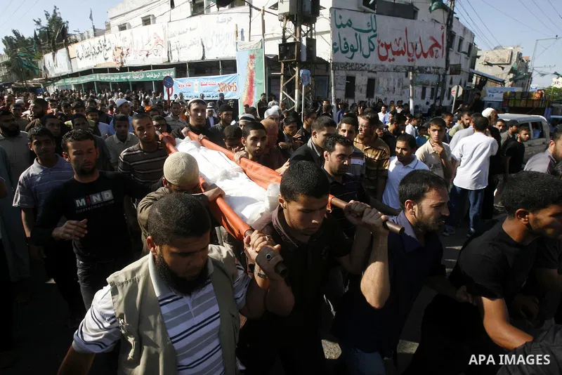 Palestinian mourners carry the body of one of three killed militants during their funeral in the southern Gaza Strip town of Rafah on May 31, 2011. Three Palestinians were killed and eight others were wounded Tuesday in...