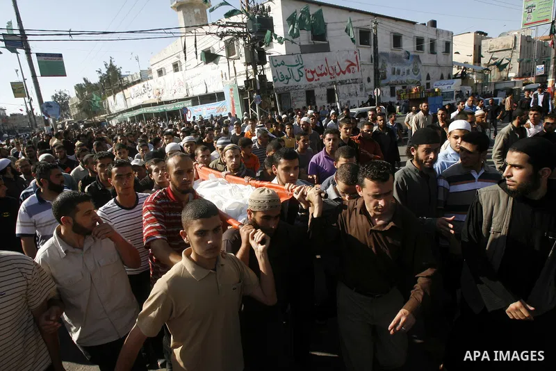 Palestinian mourners carry the body of one of three killed militants during their funeral in the southern Gaza Strip town of Rafah on May 31, 2011. Three Palestinians were killed and eight others were wounded Tuesday in...
