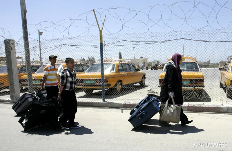 Palestinians wait to cross into Egypt through the Rafah border crossing in the southern Gaza Strip on June 1, 2011. Gaza's Hamas rulers said on Wednesday that Egypt limited the number of people allowed to enter from Gaza...