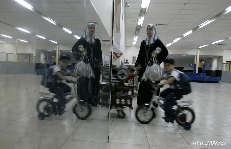 Palestinians wait to cross into Egypt through the Rafah border crossing in the southern Gaza Strip on June 1, 2011. Gaza's Hamas rulers said on Wednesday that Egypt limited the number of people allowed to enter from Gaza...