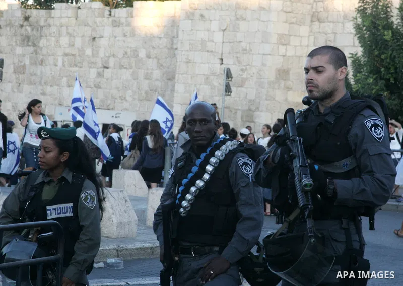 Israeli soldiers stand guard as Israelis march at Damascus Gate, the main entrance to the old city of Jerusalem on June 1, 2011 as some 40,000 Jewish Israelis joined a Jerusalem Day parade in the city's mainly Arab easte...