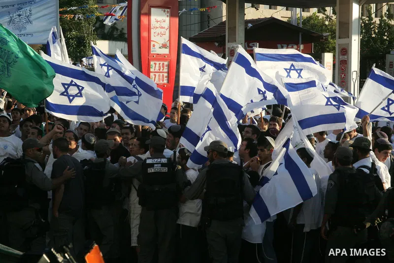 Riot policemen push back Israeli marchers at Damascus Gate, the main entrance to the old city of Jerusalem, after they started chanting "Death to Arabs" while throwing vegetables, sticks and stones at Palestinian shopkee...