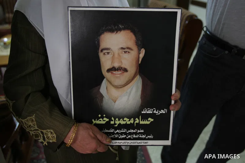 A Palestinian woman holds a picture for Hussam Khader after Israeli army forces arrest him. militants of the Fatah Chairman of the Committee to Defend Refugee Rights in the West Bank in Balata refugee camp, near Nablus ,...