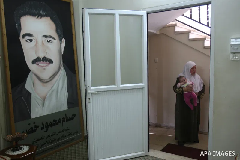 A Palestinian woman stands inside a room following a raid at her house by Israeli army forces after arrested ,Hussam Khader , militants of the Fatah Chairman of the Committee to Defend Refugee Rights in the West Bank in...