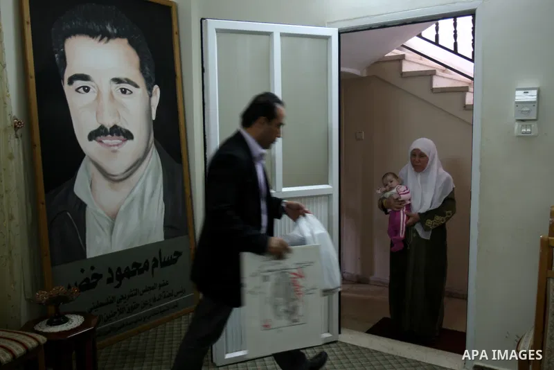 A Palestinian woman stands inside a room following a raid at her house by Israeli army forces after arrested ,Hussam Khader , militants of the Fatah Chairman of the Committee to Defend Refugee Rights in the West Bank in...