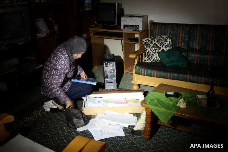 A Palestinian woman stands inside a room following a raid at her house by Israeli army forces after arrested ,Hussam Khader , militants of the Fatah Chairman of the Committee to Defend Refugee Rights in the West Bank in...