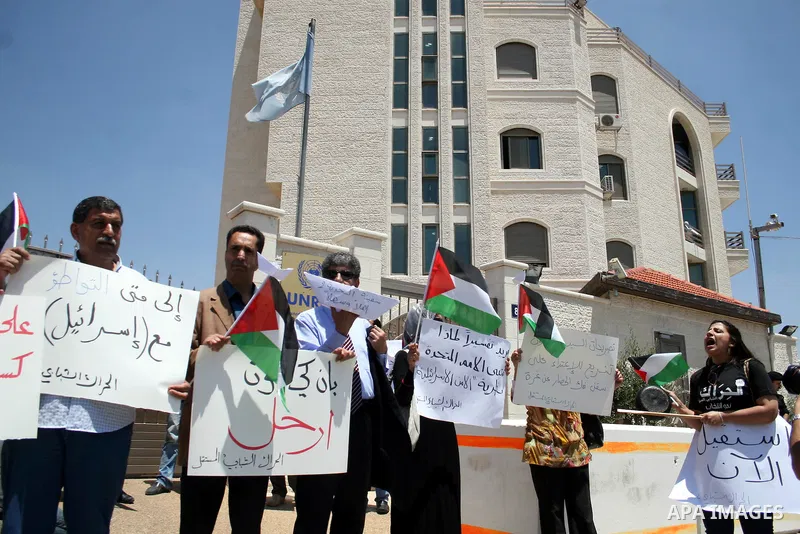 Palestinians protest in front of the UN headquarters in the West Bank city of Ramallah against UN chief Ban Ki-moon's call "on all governments" in the region to use to their influence to push against a new flotilla of sh...
