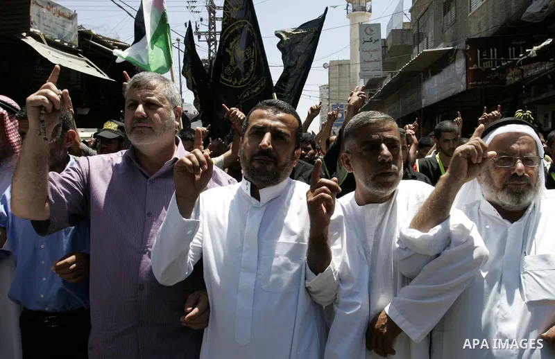 Palestinian Islamic Jihad supporters shout slogans as they march in the Khan Yunis refugee camp in the southern Gaza Strip on June 03, 2011 to mark the 44th anniversary of Six Day War and the annexation of east Jerusalem...