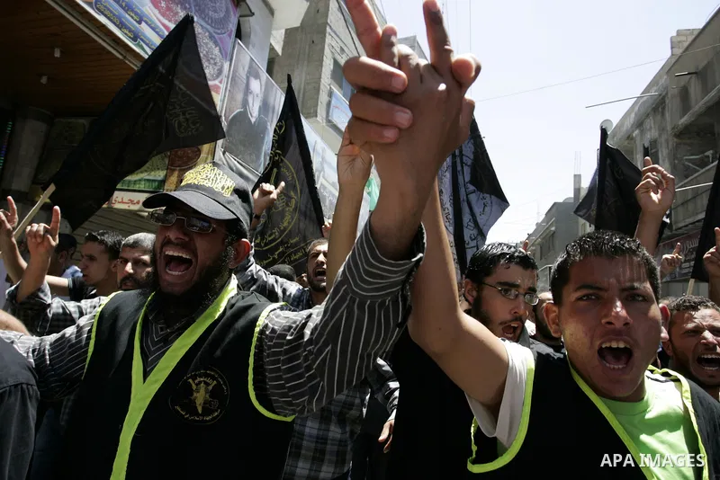 Palestinian Islamic Jihad supporters shout slogans as they march in the Khan Yunis refugee camp in the southern Gaza Strip on June 03, 2011 to mark the 44th anniversary of Six Day War and the annexation of east Jerusalem...