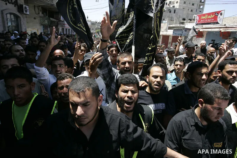 Palestinian Islamic Jihad supporters shout slogans as they march in the Khan Yunis refugee camp in the southern Gaza Strip on June 03, 2011 to mark the 44th anniversary of Six Day War and the annexation of east Jerusalem...