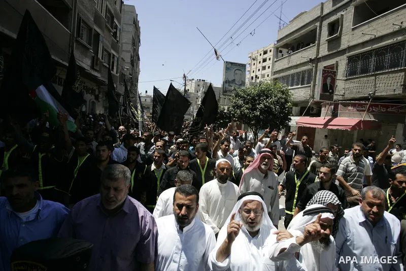 Palestinian Islamic Jihad supporters shout slogans as they march in the Khan Yunis refugee camp in the southern Gaza Strip on June 03, 2011 to mark the 44th anniversary of Six Day War and the annexation of east Jerusalem...