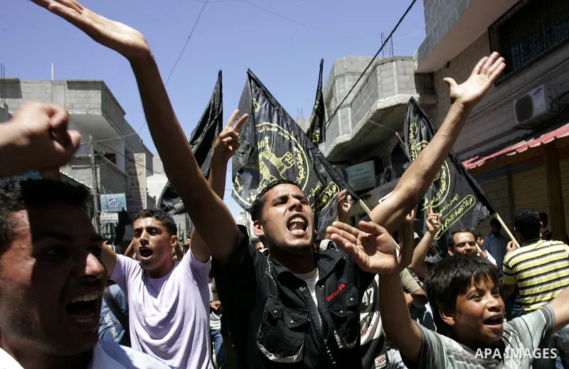Palestinian Islamic Jihad supporters shout slogans as they march in the Khan Yunis refugee camp in the southern Gaza Strip on June 03, 2011 to mark the 44th anniversary of Six Day War and the annexation of east Jerusalem...