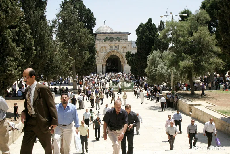 Palestinian Muslim worshipers walk in front of Al-Aqsa mosque after Friday prayer at the Al-Aqsa mosque compound in Jerusalem's Old City on June 03, 2011 as Israeli police restricted the entrance age to men over 45 at th...
