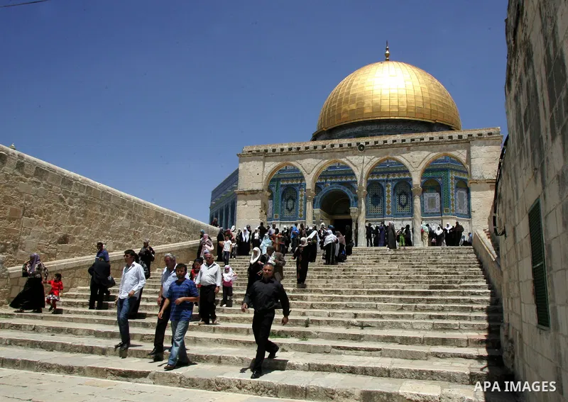 Palestinian Muslim worshipers walk in front of the Dome of the Rock after Friday prayer at the Al-Aqsa mosque compound in Jerusalem's Old City on June 03, 2011 as Israeli police restricted the entrance age to men over 45...