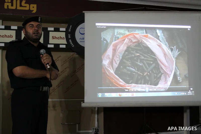 A Palestinian policeman from the Islamic Hamas movement displays a video for confiscated drugs and drug addicts and dealers in Gaza City on June 3, 2011, following a military operation. Drug use was once rare in Gaza's c...