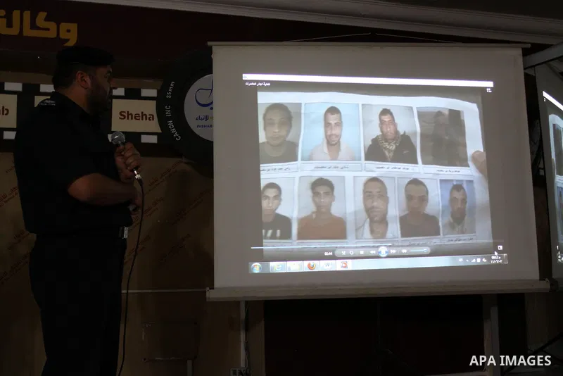 A Palestinian policeman from the Islamic Hamas movement displays a video for confiscated drugs and drug addicts and dealers in Gaza City on June 3, 2011, following a military operation. Drug use was once rare in Gaza's c...