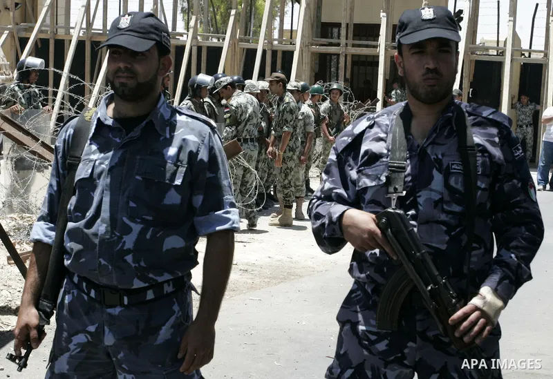 Hamas policemen stand in front of Egyptian soldiers as they prevent Palestinians from coming close to the iron gate of a border crossing with Egypt in the southern Gaza strip June 4, 2011. Egyptian officials at the borde...