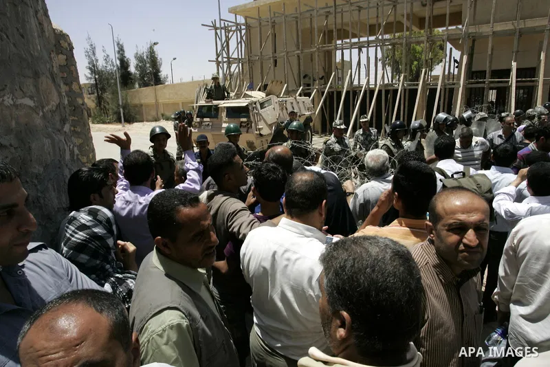 Palestinians wanting to cross into Egypt through the Rafah border crossing are stopped on June 4, 2011, as Egyptian officials at the border with Gaza barred Palestinians from crossing, but later allowed them passage out...