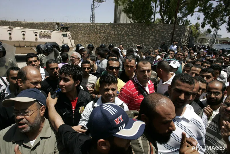 Palestinians wanting to cross into Egypt through the Rafah border crossing are stopped on June 4, 2011, as Egyptian officials at the border with Gaza barred Palestinians from crossing, but later allowed them passage out...