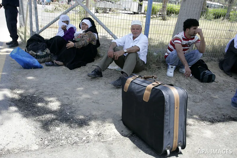 Palestinians wanting to cross into Egypt through the Rafah border crossing are stopped on June 4, 2011, as Egyptian officials at the border with Gaza barred Palestinians from crossing, but later allowed them passage out...