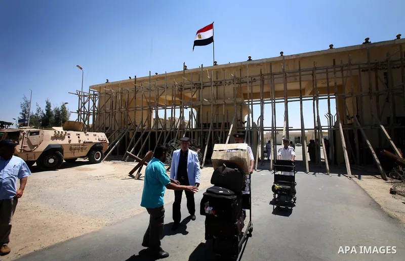 Egyptian soldiers help Palestinian passengers at the Rafah border crossing in the southern Gaza Strip 04 June 2011. Egyptian authorities reopened its Rafah border crossing with the Gaza Strip after a temporary closure wh...