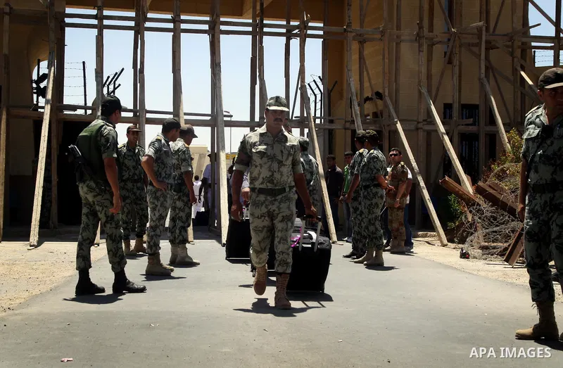 Egyptian soldiers help Palestinian passengers at the Rafah border crossing in the southern Gaza Strip 04 June 2011. Egyptian authorities reopened its Rafah border crossing with the Gaza Strip after a temporary closure wh...