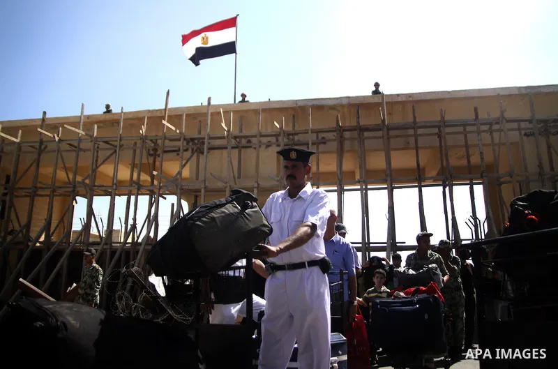 Egyptian soldiers help Palestinian passengers at the Rafah border crossing in the southern Gaza Strip 04 June 2011. Egyptian authorities reopened its Rafah border crossing with the Gaza Strip after a temporary closure wh...