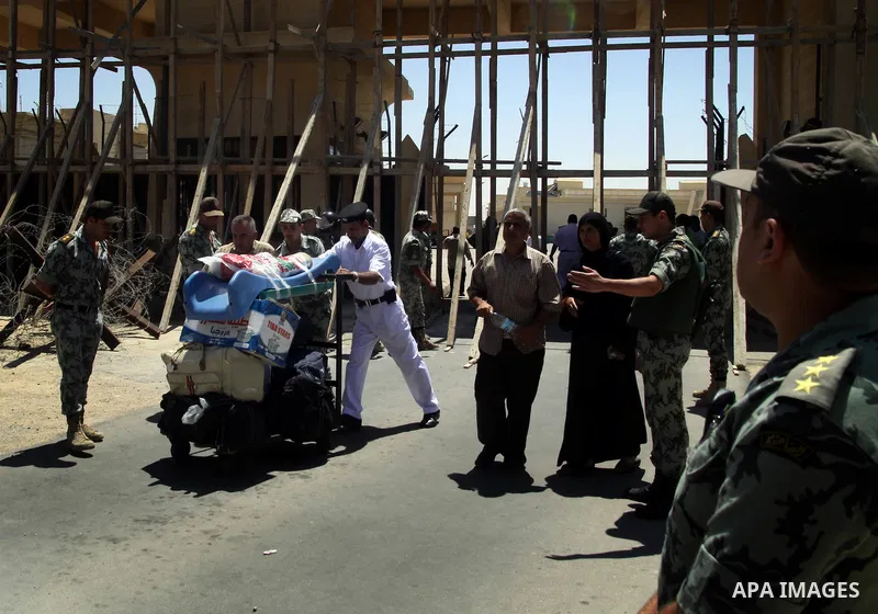 Egyptian soldiers help Palestinian passengers at the Rafah border crossing in the southern Gaza Strip 04 June 2011. Egyptian authorities reopened its Rafah border crossing with the Gaza Strip after a temporary closure wh...