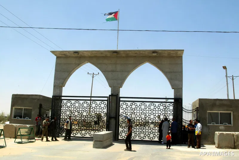 Palestinians stand in front of the iron gate of the Rafah border crossing with Egypt in the southern Gaza Strip on June 5, 2011. While Chairman of the border crossings in Gaza Strip, Hatem Aweidah said that the Rafah bor...