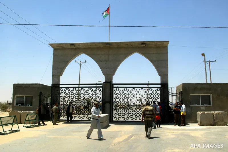 Palestinians stand in front of the iron gate of the Rafah border crossing with Egypt in the southern Gaza Strip on June 5, 2011. While Chairman of the border crossings in Gaza Strip, Hatem Aweidah said that the Rafah bor...